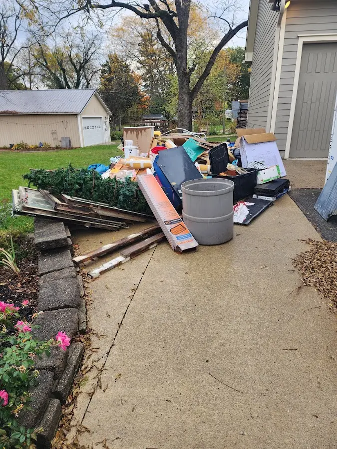 Dumpster being loaded with debris for Roofing Dumpster Rental in Stonington